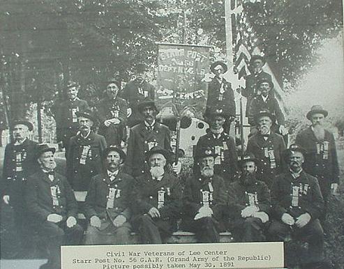 Group of men wearing Union Army uniforms posing in front of an American flag