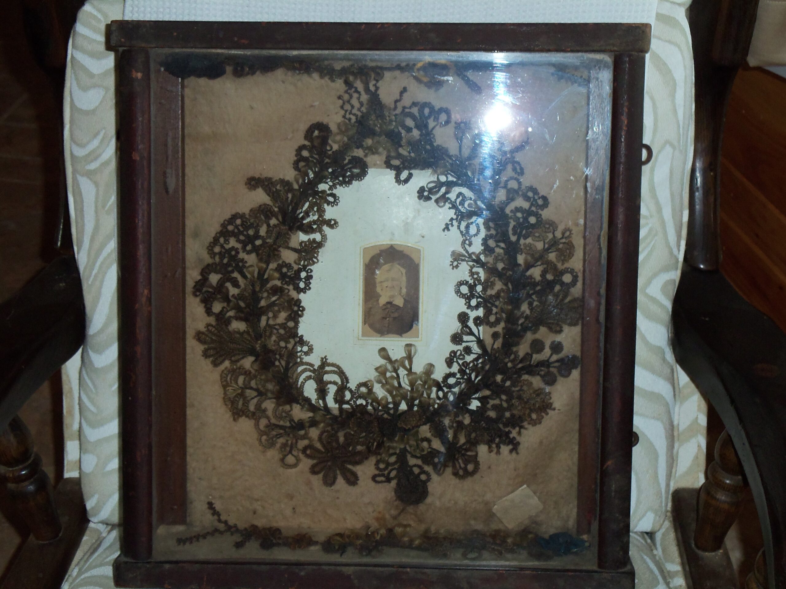Portrait of elderly woman centered in a wreath made from brunette hair