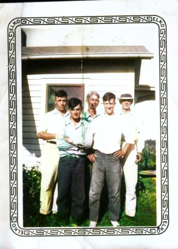 Group of men pose for photo outdoors