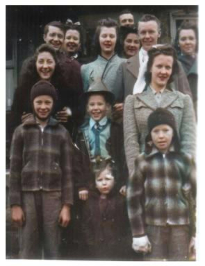 Family photo of children and young adults dressed in 1940s style clothes