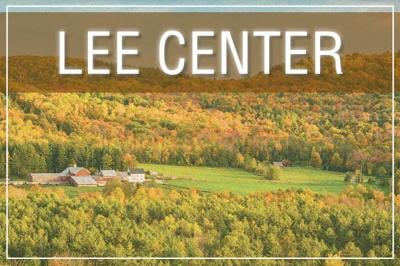 Small farm nestled in heavily wooded area. captioned LEE CENTER 