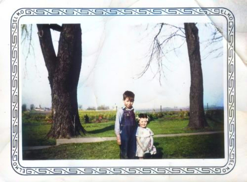 a young boy and toddler girl pose outdoors for a photo