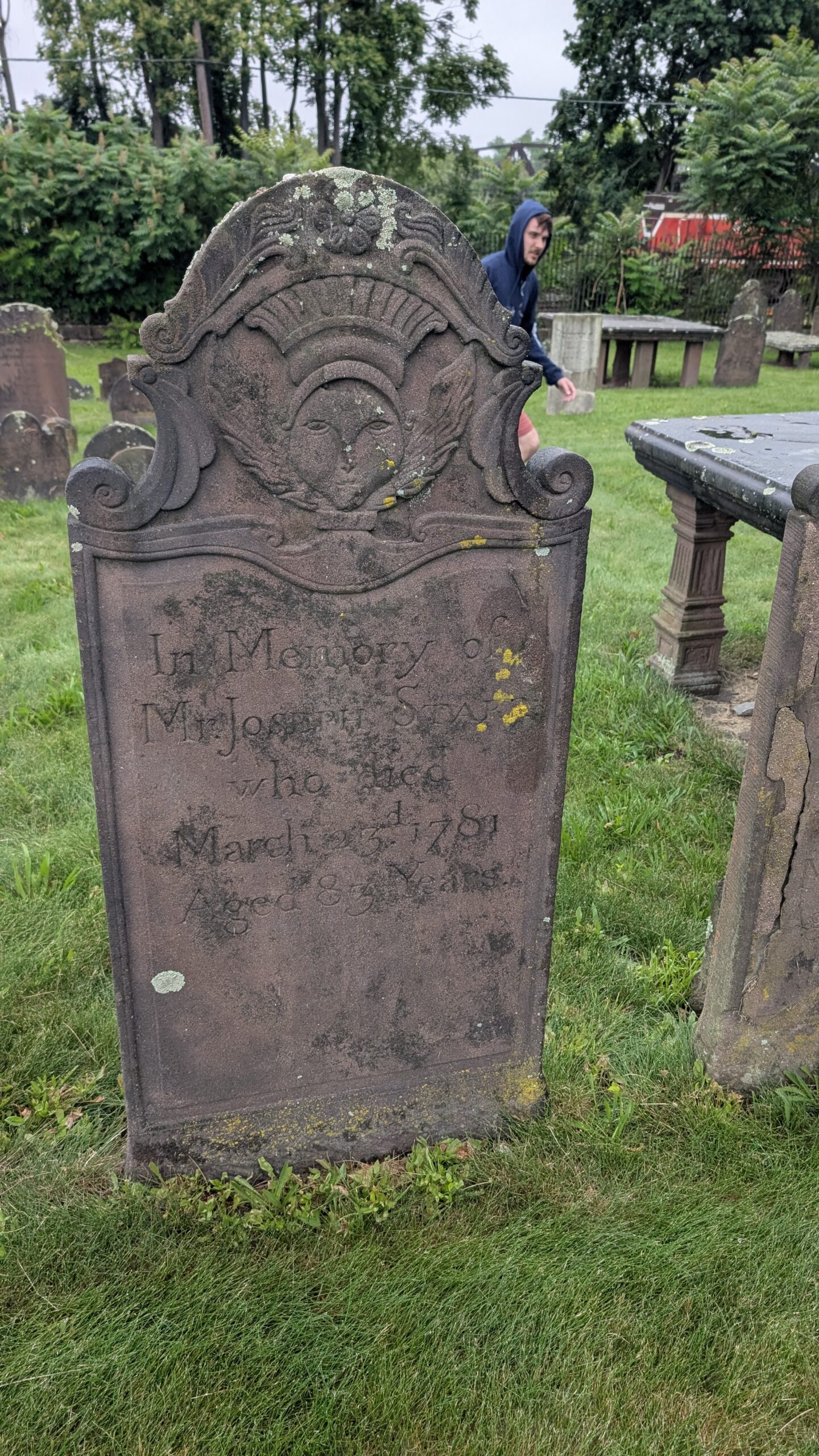 ornate brownstone grave stone with a face carved in it and the words In Memory of Mr Joseph Starr who died 13 July 1758
