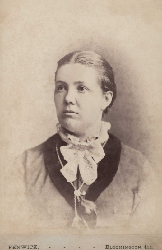 sepia portrait of a young woman dressed in formal 1800s attire